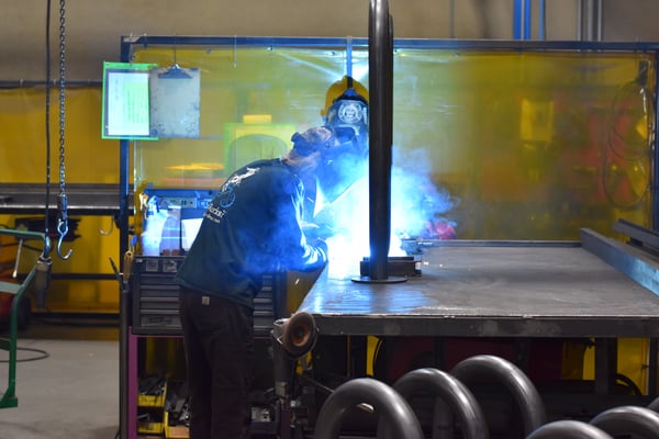 Person welding bike rack