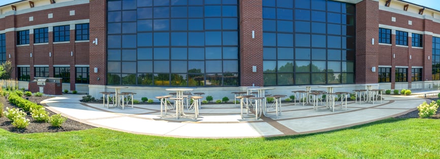 Thomas Steele bar height courtyard tables on a business patio.